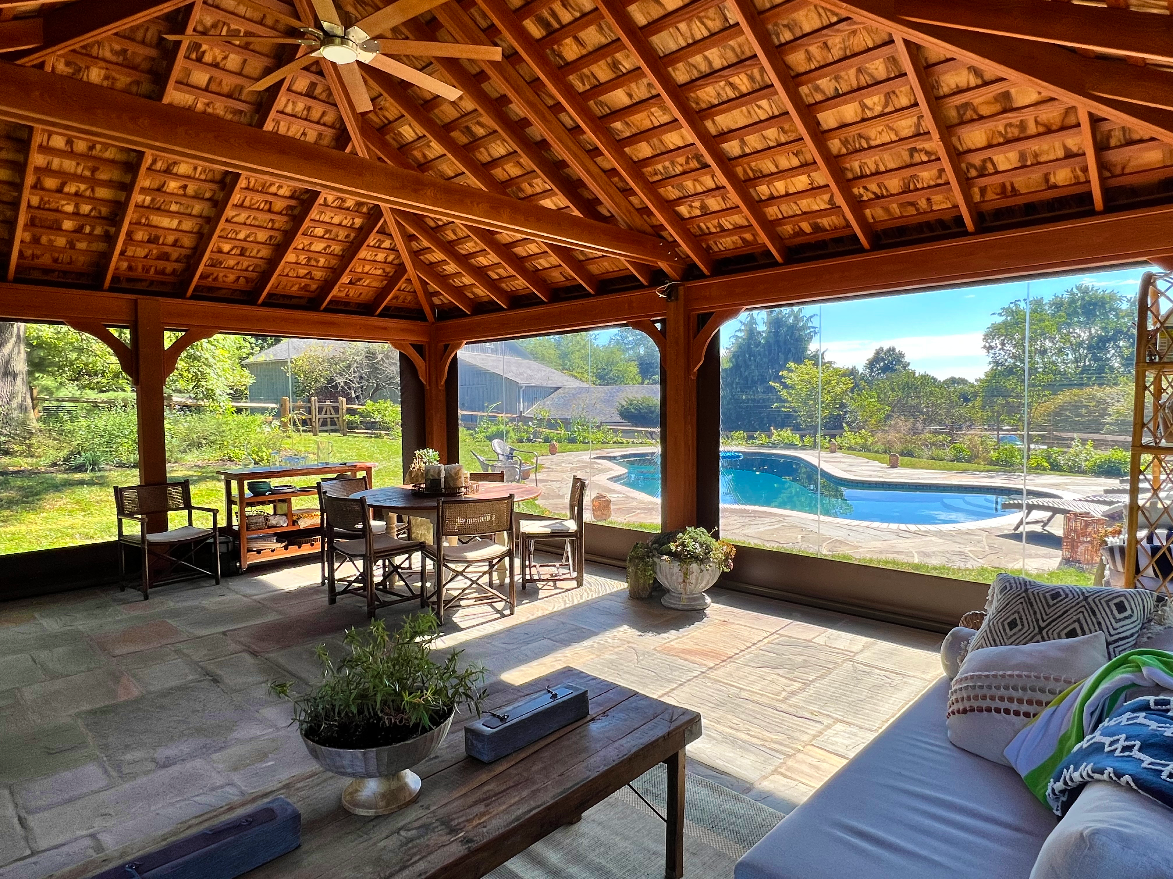 Red pavilion over patio overlooking pool