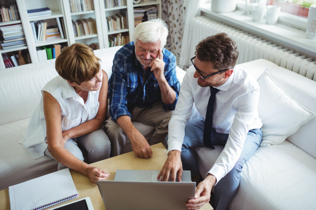 Three people reviewing proposal on a computer