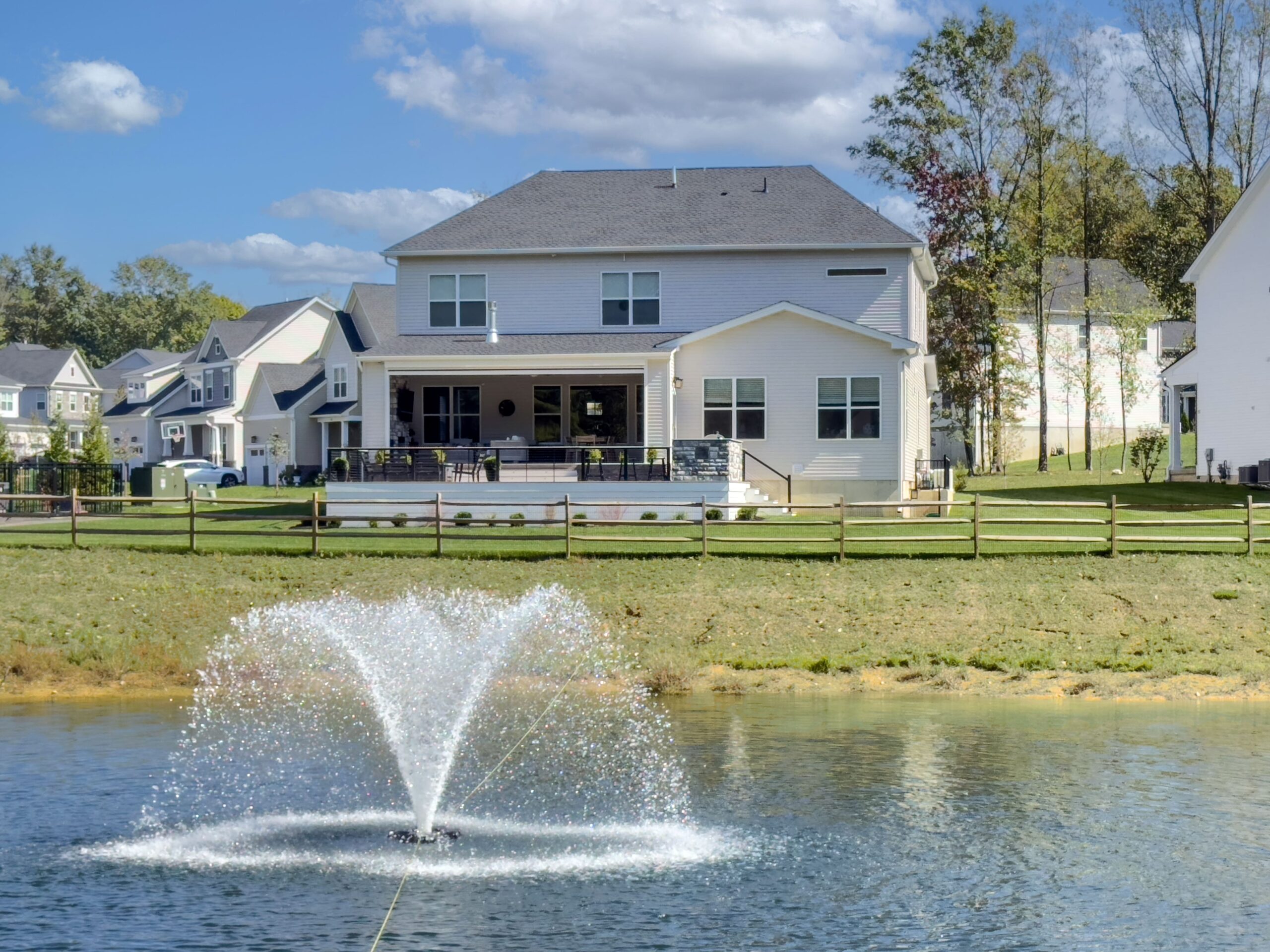 Large house in front of a pond