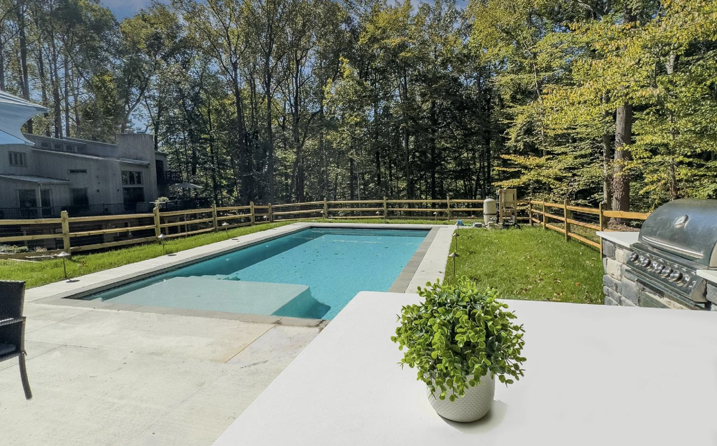 Pool with patio and outdoor kitchen