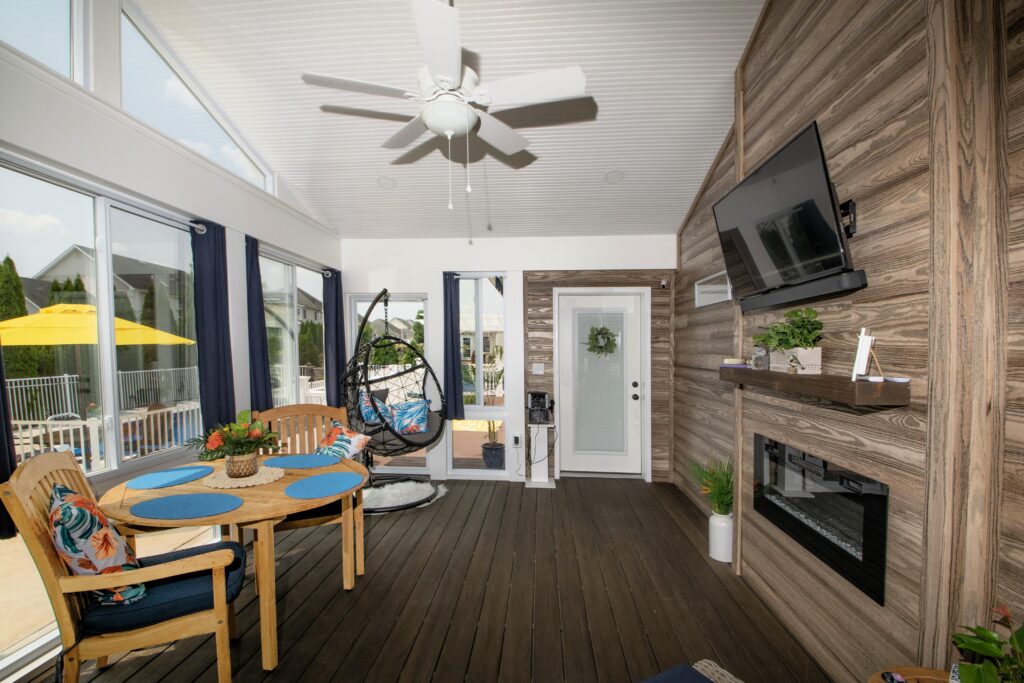 Sunroom with fireplace, ceiling fan and furniture