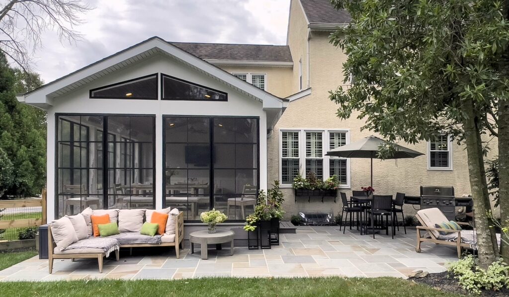 Sunroom with black framed floor to ceiling windows