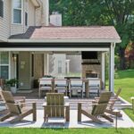 Looking at covered porch and fire pit