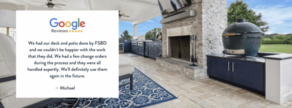 Testimonial for FSBD overlays an outdoor patio with a fireplace, grill, blue cabinets, and a ceramic smoker. The review praises FSBD’s work and customer service, ending with a 5-star Google rating and signed by Michael.